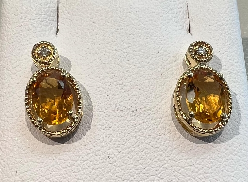 10k yellow gold citrine and diamond earrings.

2 Citrine 7x5mm
2 Fancy Cut Diamonds 0.02ct

Canadian Certified Gold.