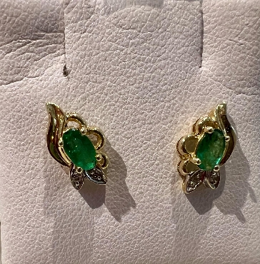 Yellow gold emerald and diamond earrings.