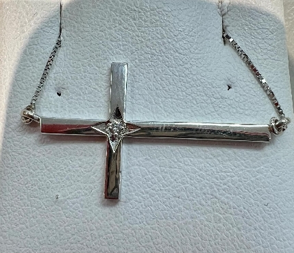 10k white gold cross pendant with diamond.

1 fancy cut diamond 0.01ct

Canadian Certified Gold.